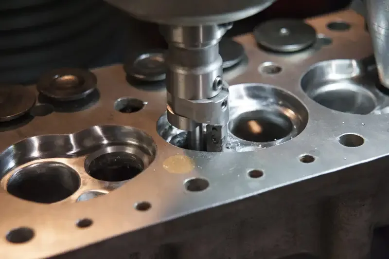 A cutter working a valve seat in a cylinder head in the Oselli machine shop